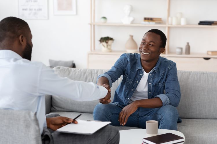 African American clinical mental health counselor with client